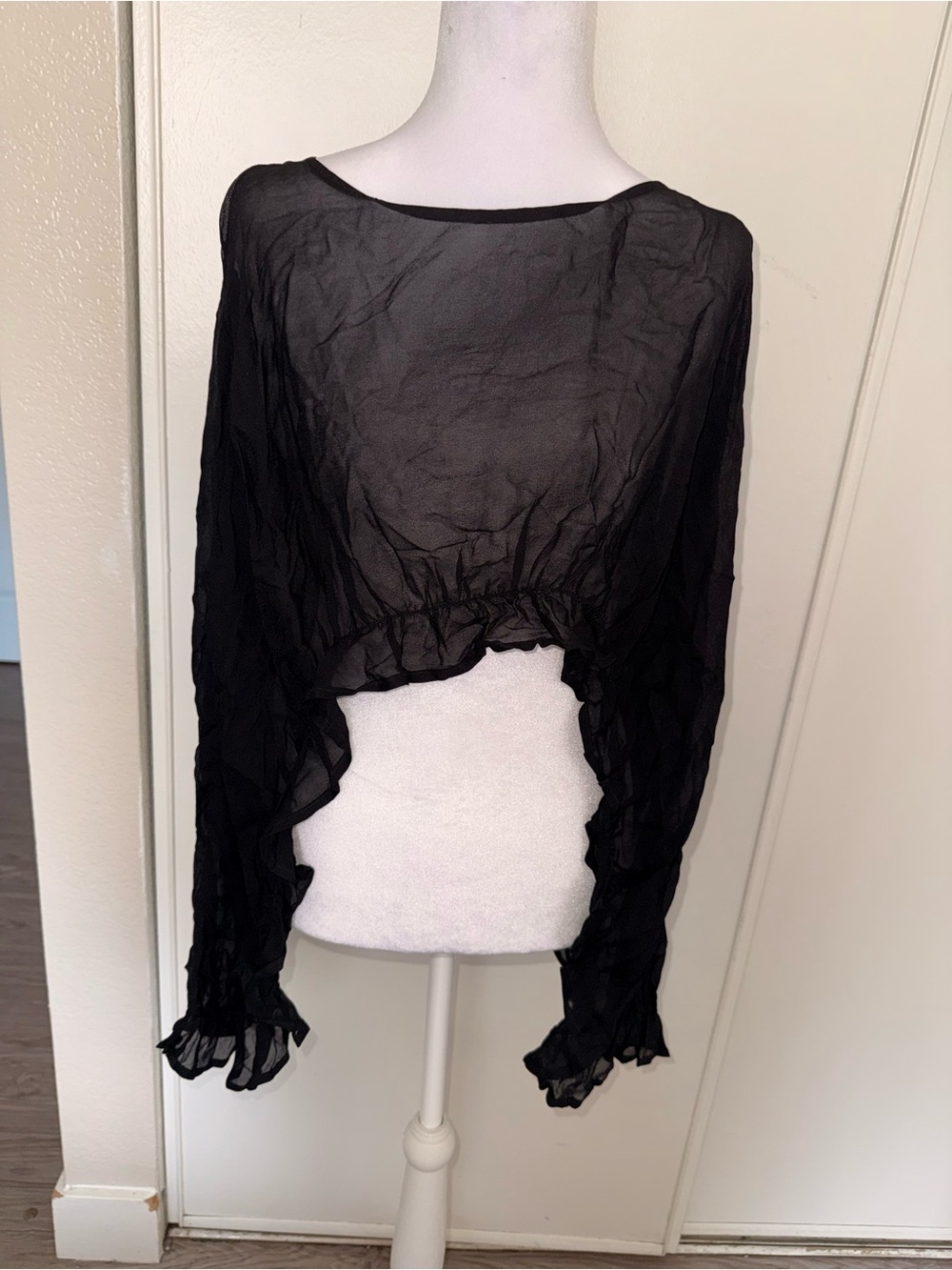 139. Bebe black sheer top with ruffled bottom